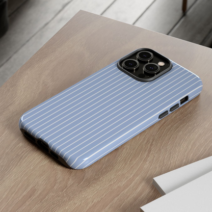 Phone case with blue and white striped pattern on a wooden surface
