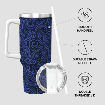 Travel mug with blue pattern, white handle, and straw on a light gray background