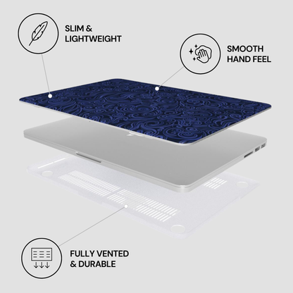 Laptop with blue patterned cover on a white background, featuring text labels about features.