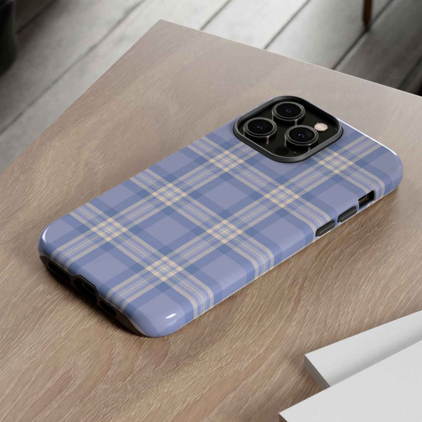 Blue plaid phone case on a wooden surface