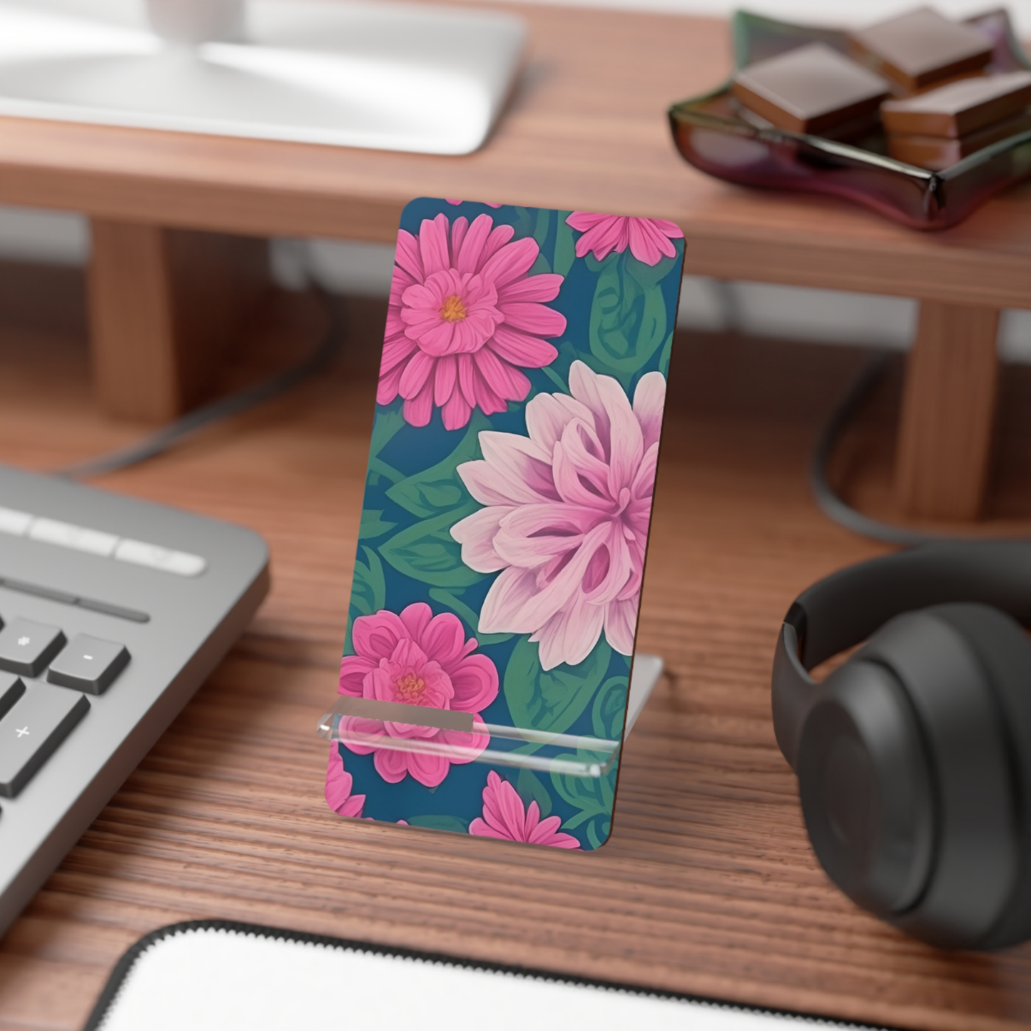 Floral phone stand on a desk with keyboard, mouse, and headphones