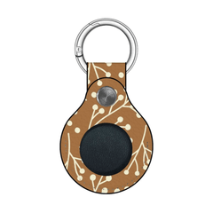 Keychain with brown pattern and black circle on a white background