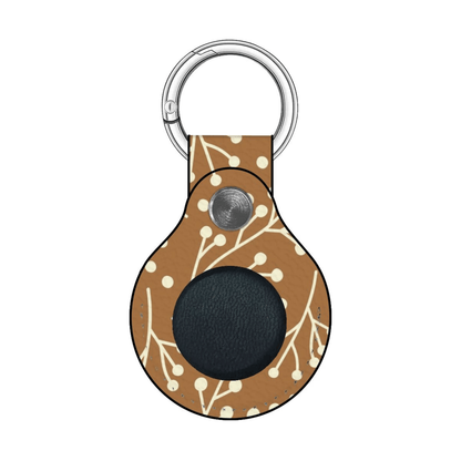 Keychain with brown pattern and black circle on a white background