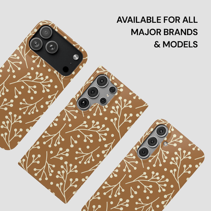 Three phone cases with a brown and white pattern on a light gray background.