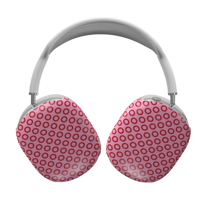 Pink and red polka dot headphones on a white background