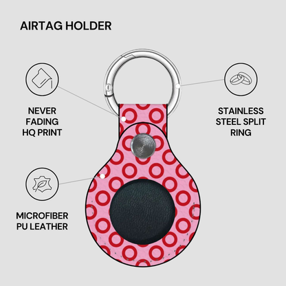 Pink airtag holder with red circular pattern on a gray background