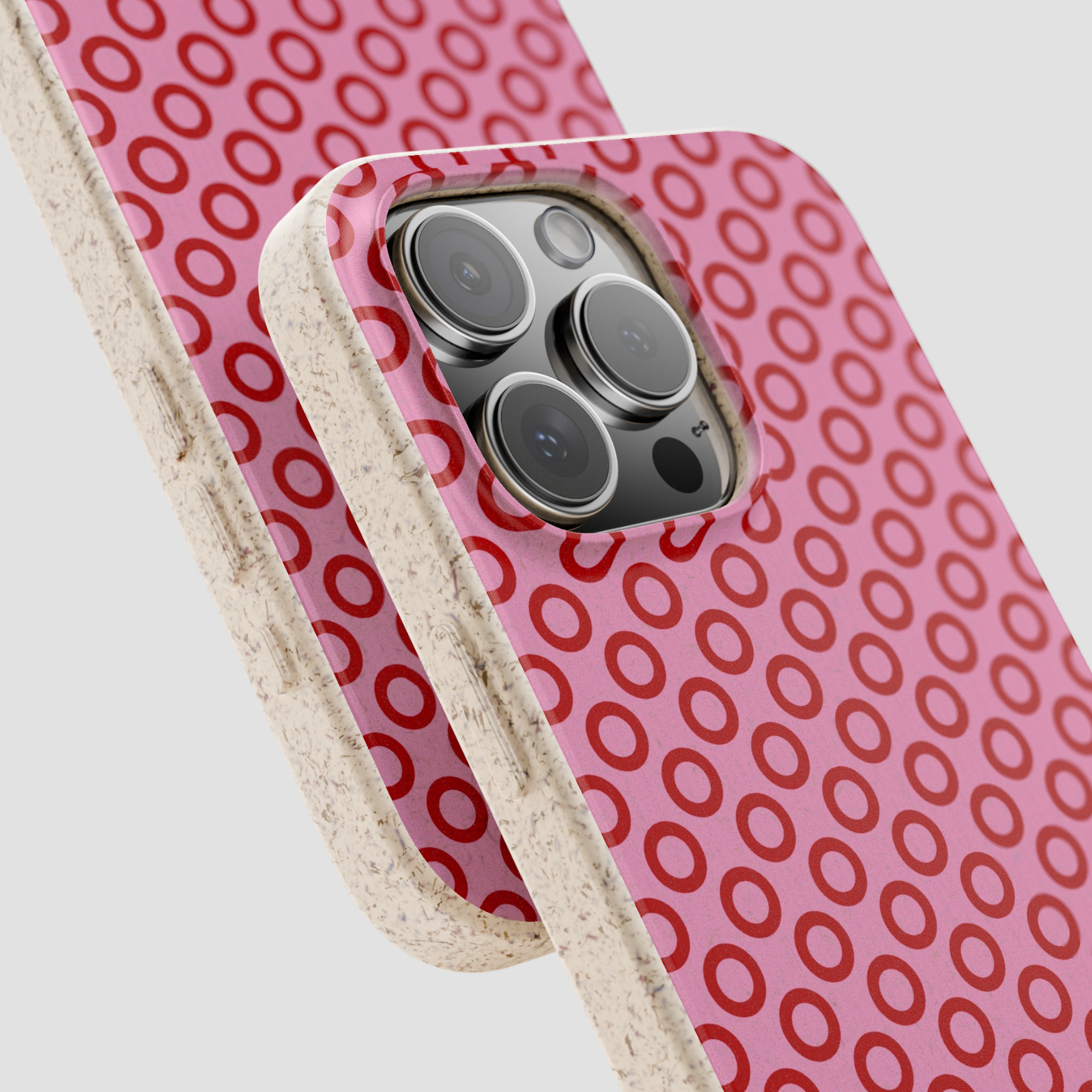 Phone case with red circular pattern and beige border on a white background