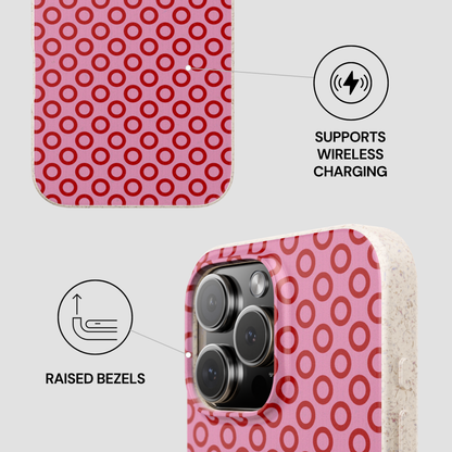Phone case with pink circular pattern, wireless charging symbol, and raised bezels text on a white background