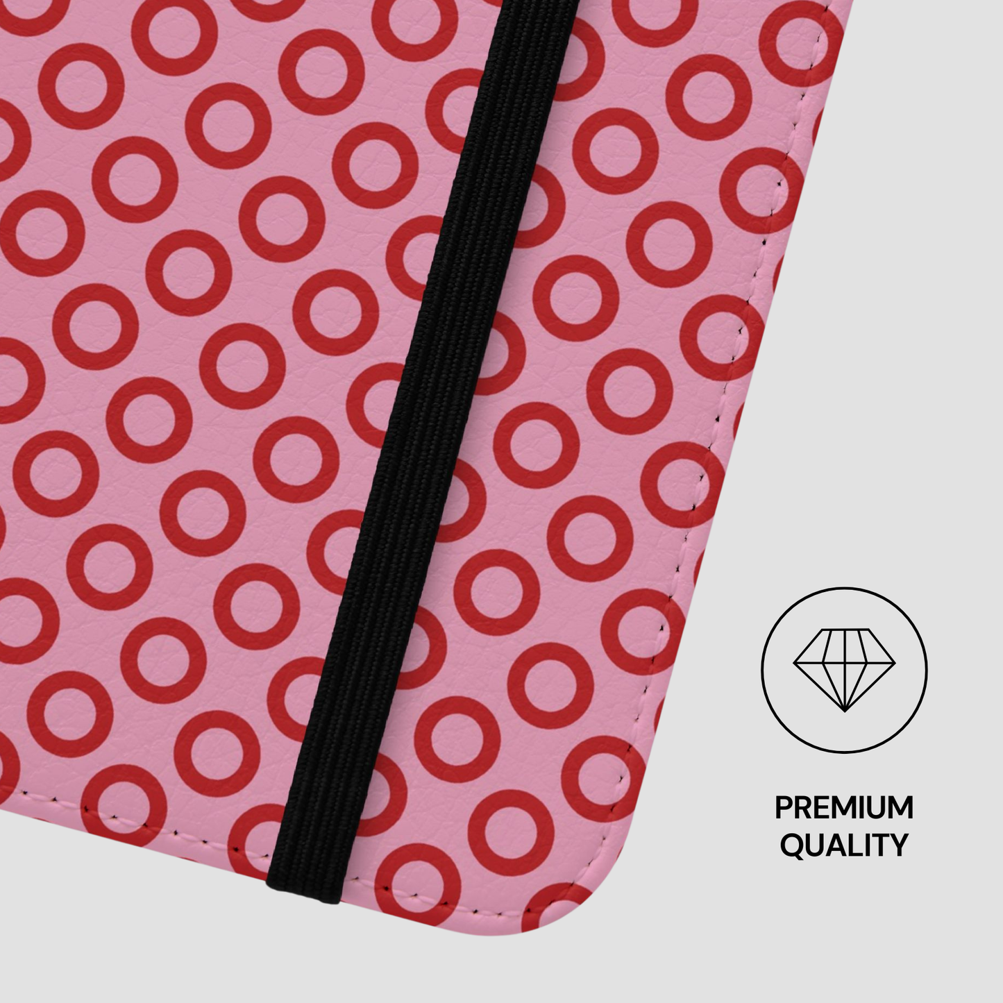 Pink notebook cover with red circular pattern and black binding, labeled 'Premium Quality'.
