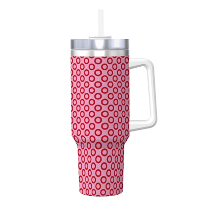Pink polka dot mug with a white handle and silver lid on a white background