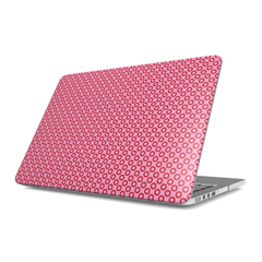 Laptop with a pink polka dot case on a white background