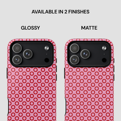 Two phone cases with pink circular pattern, one glossy and one matte, on a white background.