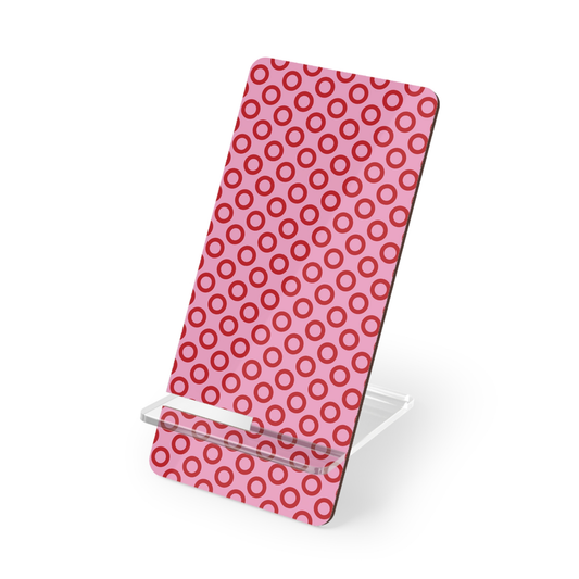 Phone stand with pink and red circular pattern on a white background