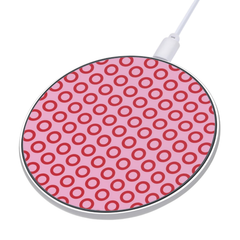 Round wireless charging pad with pink and red circular pattern on a white background