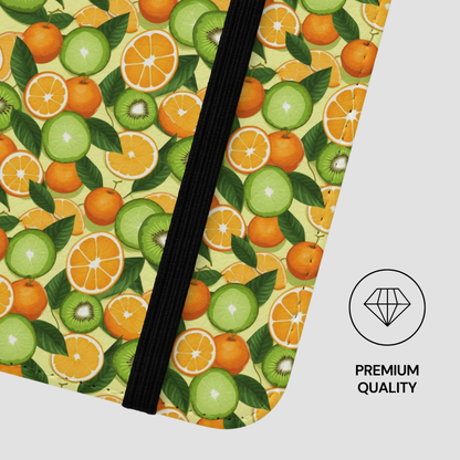 Pattern of oranges, kiwis, and leaves on a green background with a black straw.