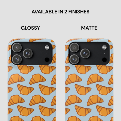 Two phone cases with croissant pattern, one glossy and one matte, on a light blue background. | Casenari