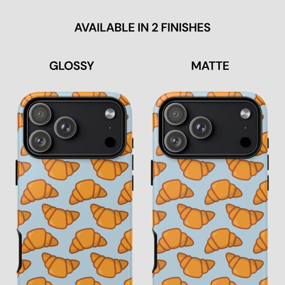 Phone case with croissant pattern on a light blue background, available in glossy and matte finishes. | Casenari