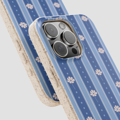 A close-up of a smartphone case with a blue striped and floral pattern, shown layered over another case on a light gray background.