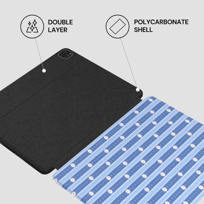 A tablet folio case shown on a light gray background with callout graphics reading 'DOUBLE LAYER' and 'POLYCARBONATE SHELL.' The closed portion is black, and the unfolded portion has blue and white diagonal stripes with small white paw-print motifs.