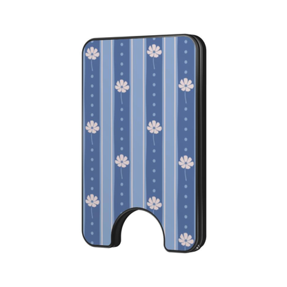 A slim rectangular card holder or wallet with rounded corners, featuring a blue and white floral stripe pattern and a black arched base, shown on a plain white background.