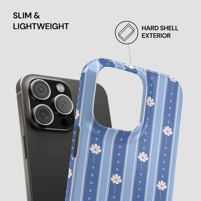 A smartphone case with a blue and white vertical stripe pattern and small white flower motifs, shown fitted over a dark gray phone. Text on the image reads 'SLIM & LIGHTWEIGHT' and 'HARD SHELL EXTERIOR' with a small icon, on a light gray background.