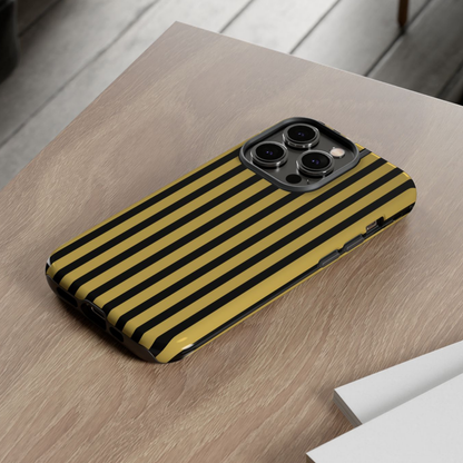 Phone case with yellow and black striped pattern on a wooden surface