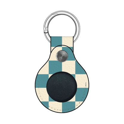 Checkered patterned keychain with a button on a white background