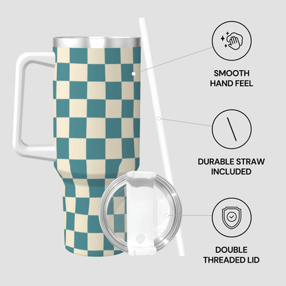 Checkered travel mug with lid and straw on a light gray background