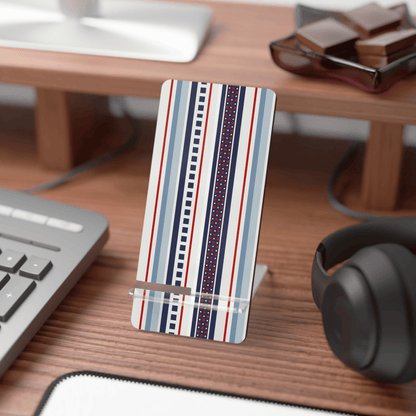 Striped phone stand on a desk with keyboard, mouse, and headphones