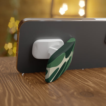 Phone case with a green and white design on a wooden surface