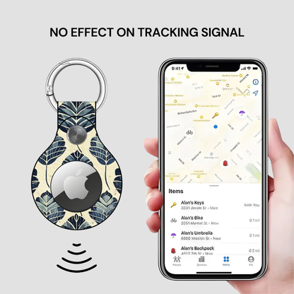 Smart keychain with leaf pattern and Apple logo, displayed next to a phone showing a location app.