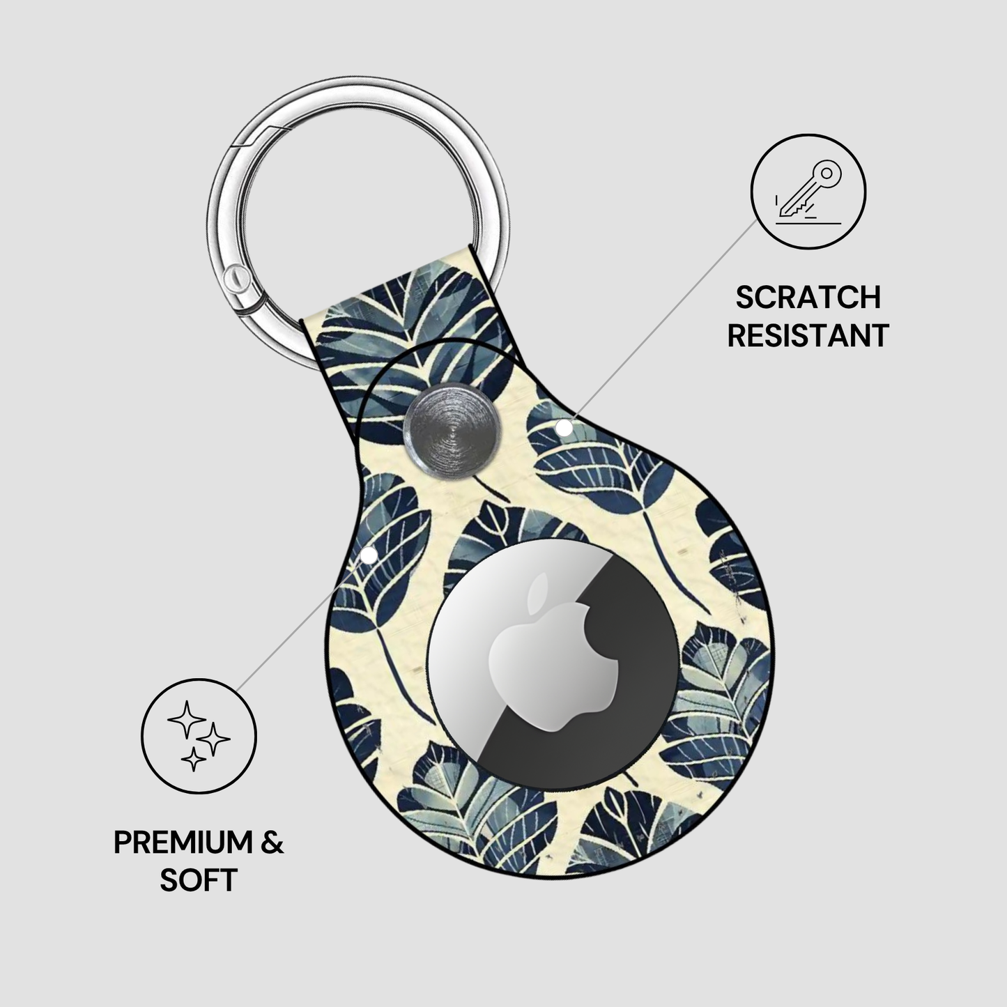 Keychain case with leaf pattern and Apple logo on a light gray background