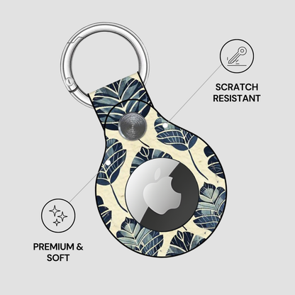 Keychain case with leaf pattern and Apple logo on a light gray background