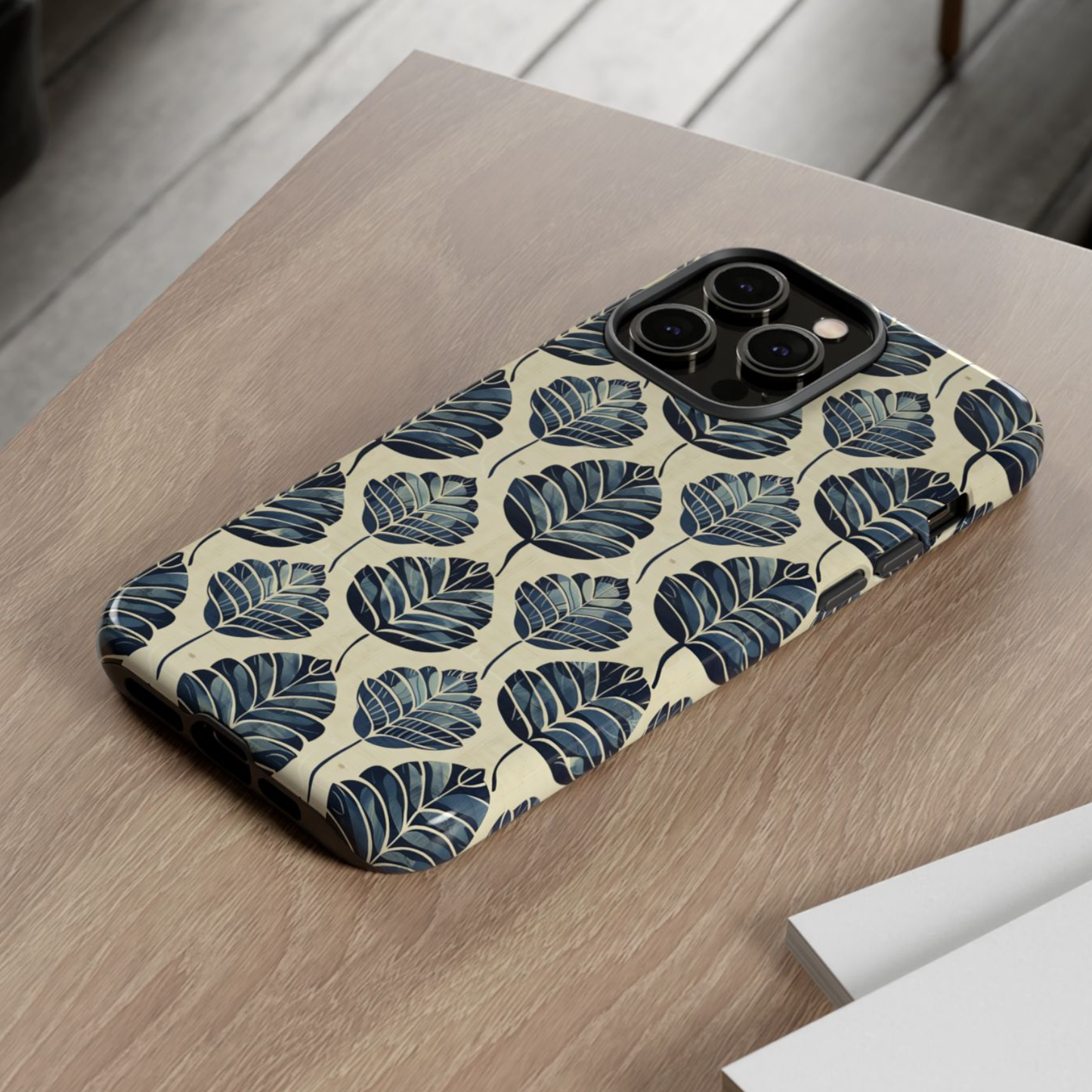 Phone case with leaf pattern on a wooden surface