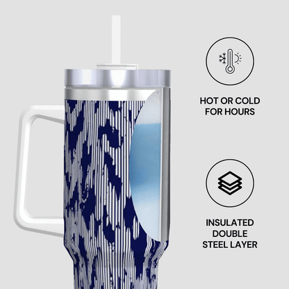 Insulated tumbler with blue camouflage pattern and white handle on a light gray background