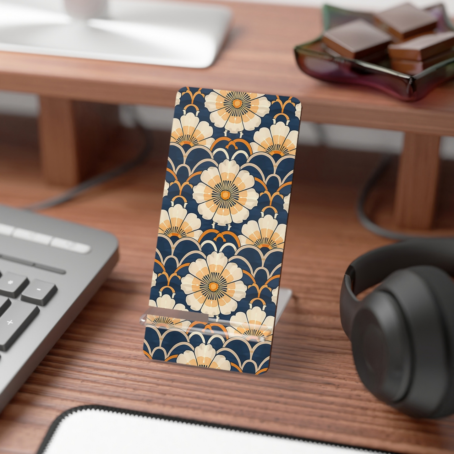 Phone case with floral pattern on a desk with computer and headphones