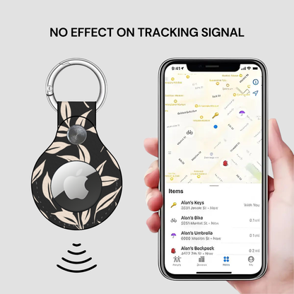 Floral-patterned keychain with Apple logo next to a phone displaying a location app.