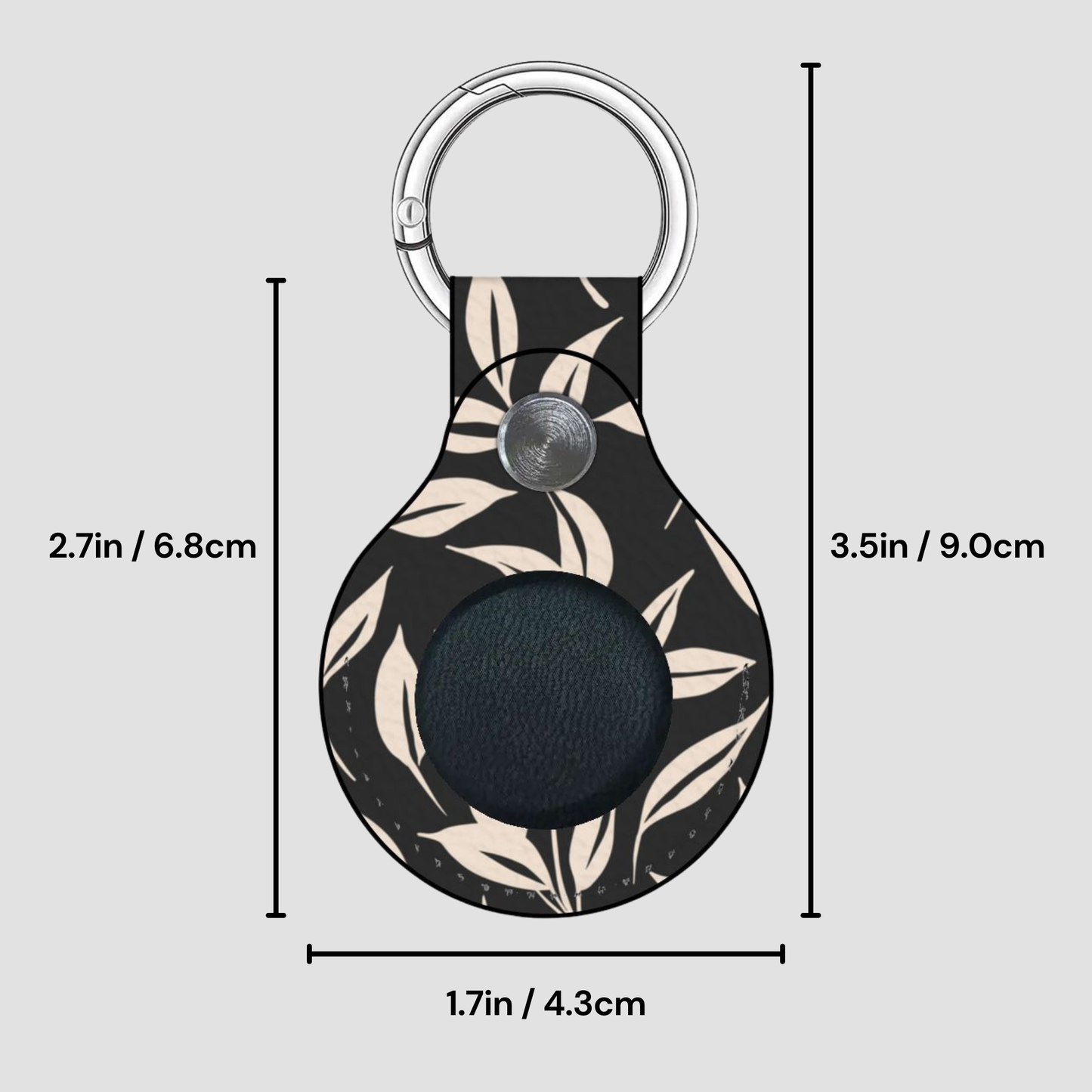 Keychain with leaf pattern and measurements on a gray background