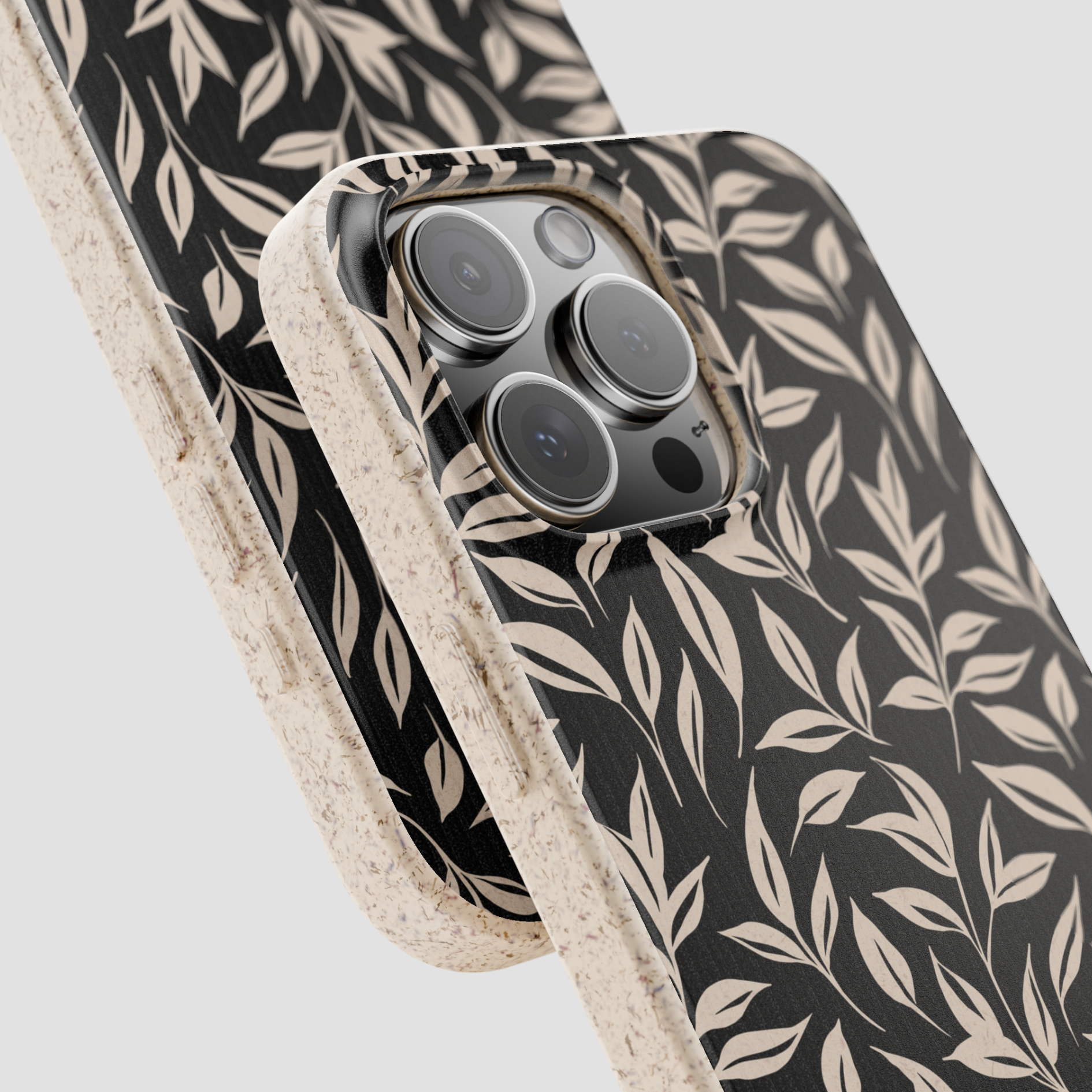 Phone case with leaf pattern on a light gray background