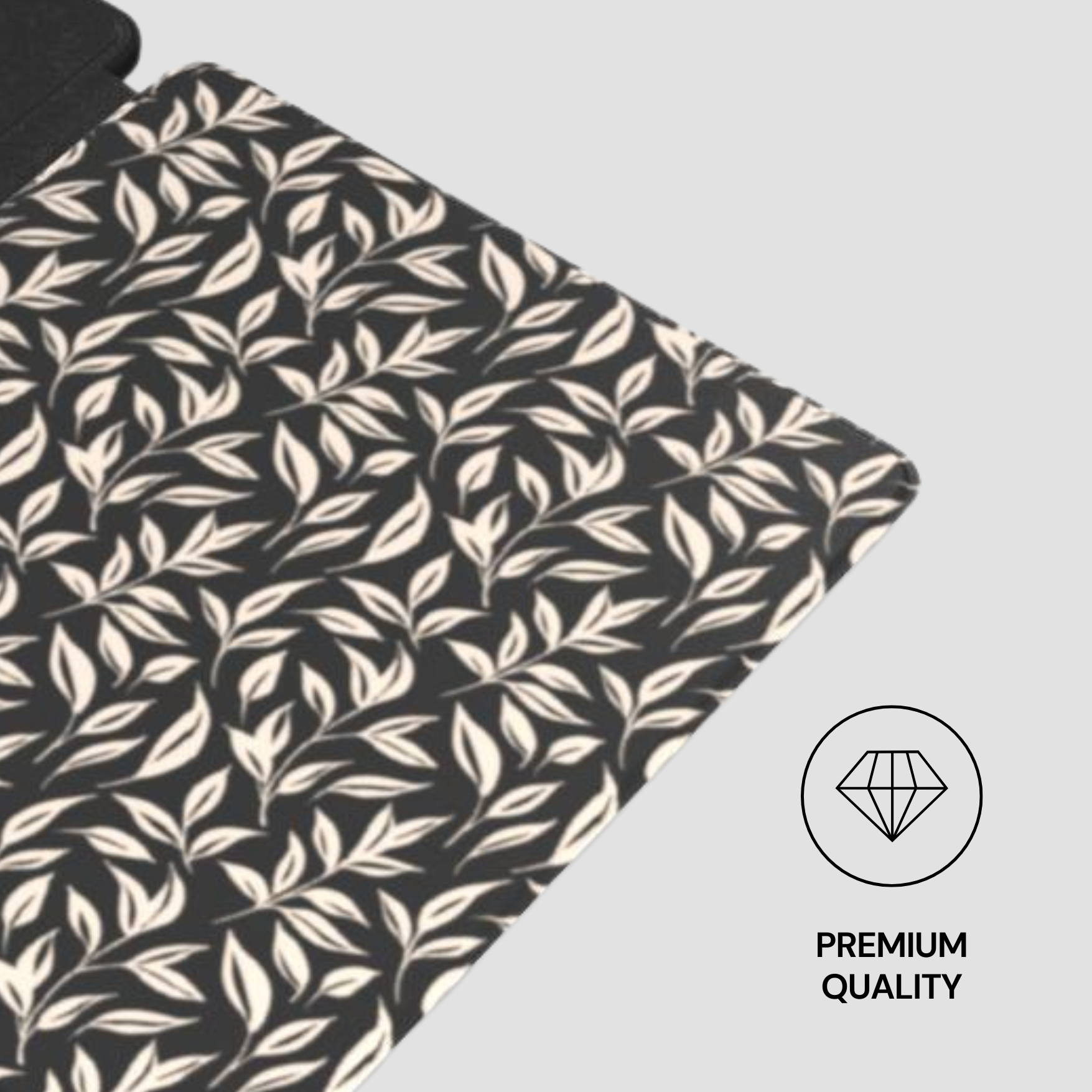 Fabric with leaf pattern on a black background, featuring a 'Premium Quality' label.