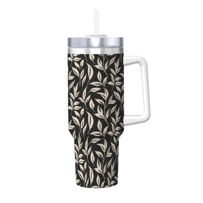 Tumbler with leaf pattern, white handle, and silver lid on a white background