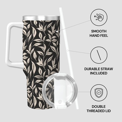 Tumbler with leaf pattern, lid, and straw on a light gray background