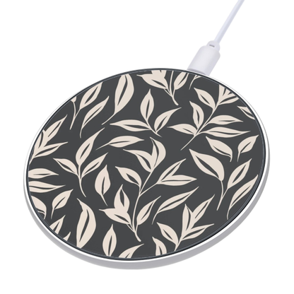 Wireless charging pad with leaf pattern on a white background