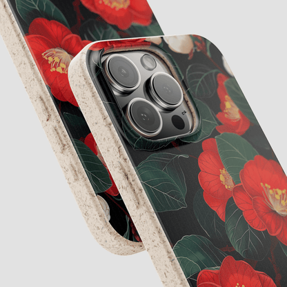 Phone case with red floral design on a black background