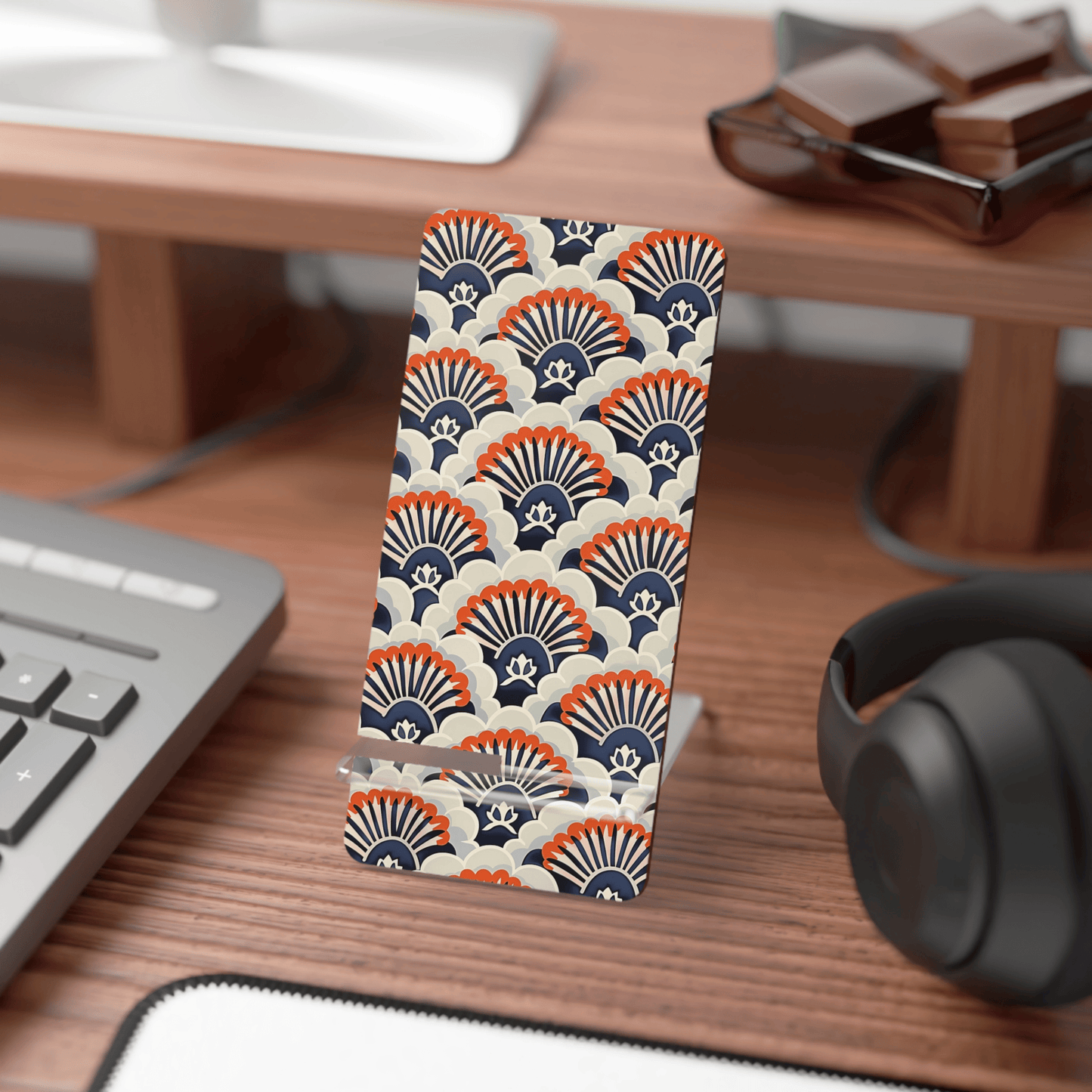 Phone case with geometric pattern on a desk with keyboard and headphones