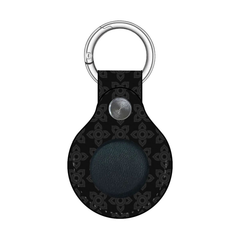 Black leather keychain with silver metal ring and button on a white background