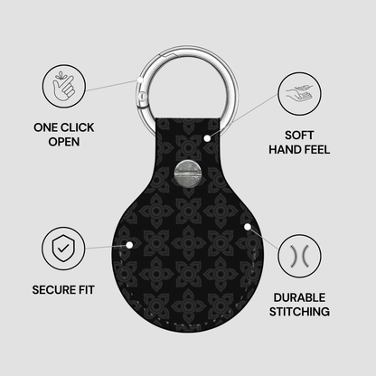 Black keychain with floral pattern on a gray background, featuring text on features.