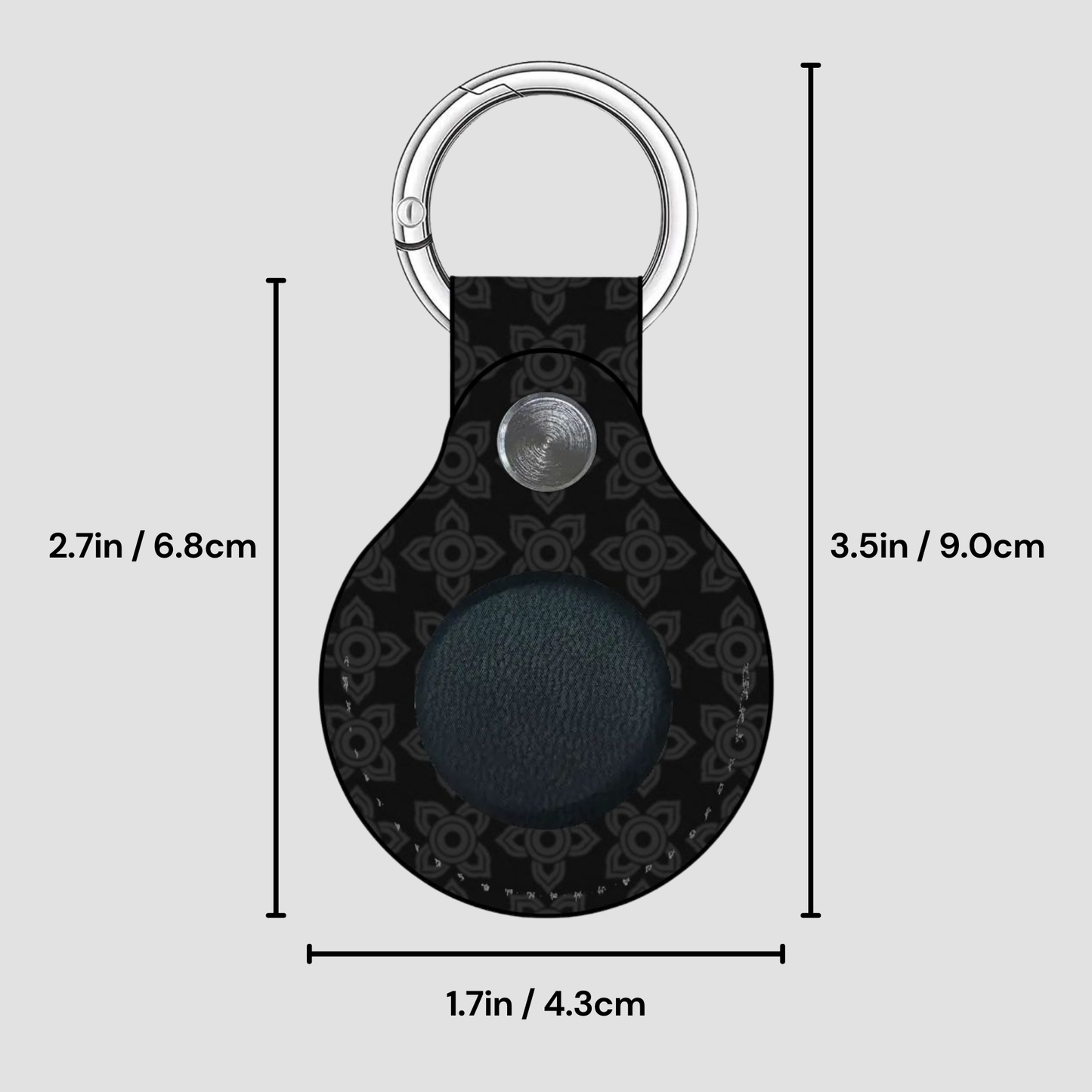 Black keychain with measurements on a gray background