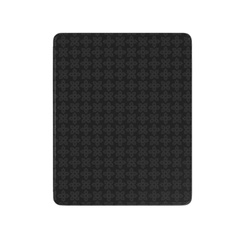 Black textured mat with geometric pattern on a white background