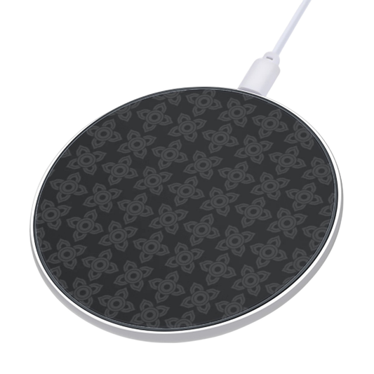 Black wireless charging pad with white cable on a white background